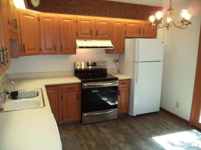 kitchen featuring freestanding refrigerator, stainless steel electric range oven, light countertops, a sink, and extractor fan