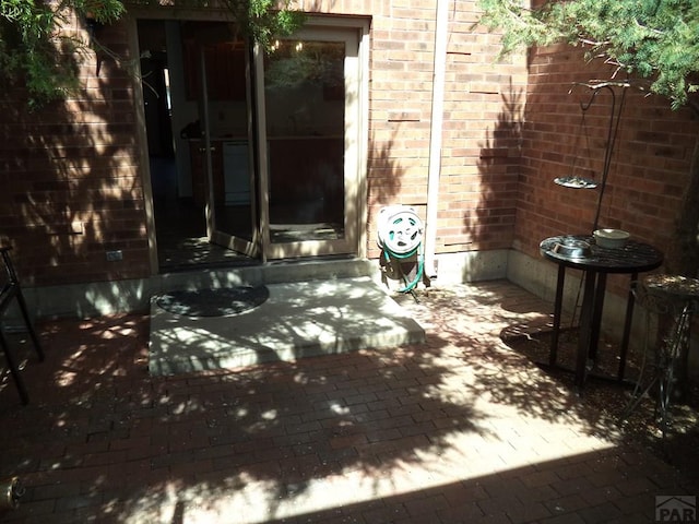 exterior space featuring brick wall