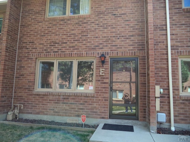 entrance to property with brick siding