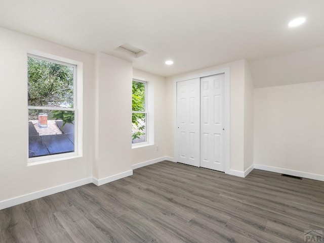 906 E 6th St, Pueblo, CO 81001 - unfurnished bedroom featuring dark wood finished floors, recessed lighting, multiple windows, and a closet