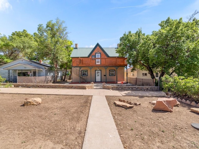 906 E 6th St, Pueblo, CO 81001 - view of front facade with covered porch and a metal roof