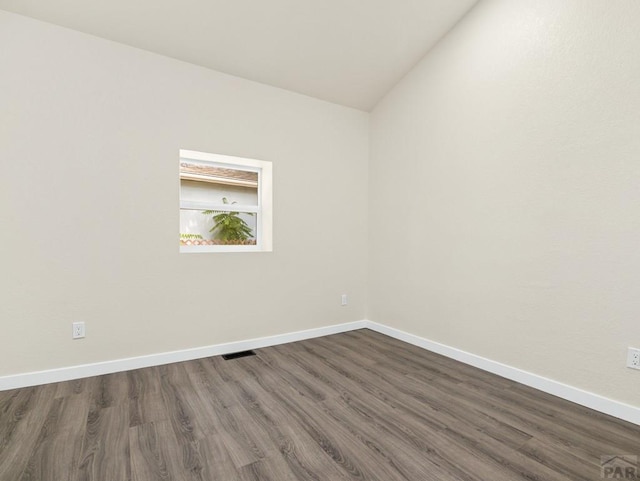 906 E 6th St, Pueblo, CO 81001 - empty room featuring dark wood-style floors and lofted ceiling