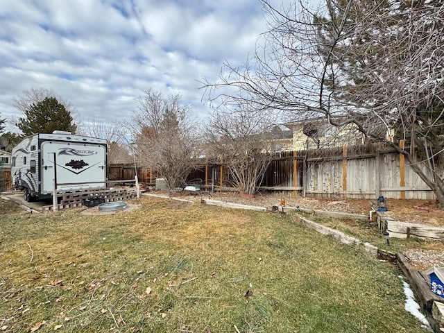 view of yard with a storage shed and a fenced backyard