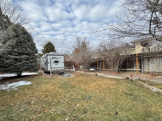 view of yard featuring an outbuilding, a fenced backyard, and a shed