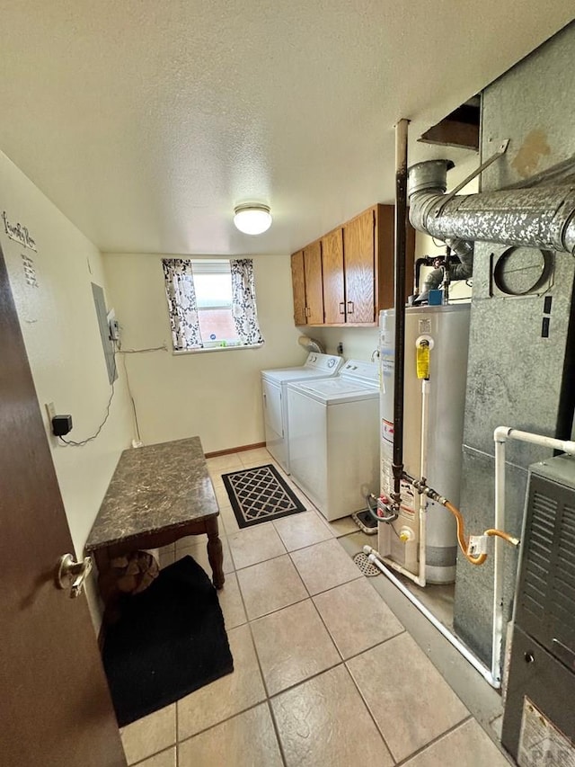 clothes washing area with a textured ceiling, light tile patterned flooring, gas water heater, cabinet space, and washer and clothes dryer