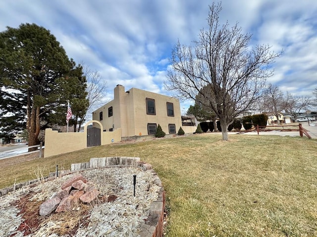 view of home's exterior with a lawn and stucco siding