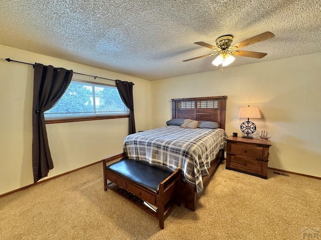 bedroom featuring a ceiling fan, light carpet, a textured ceiling, and baseboards