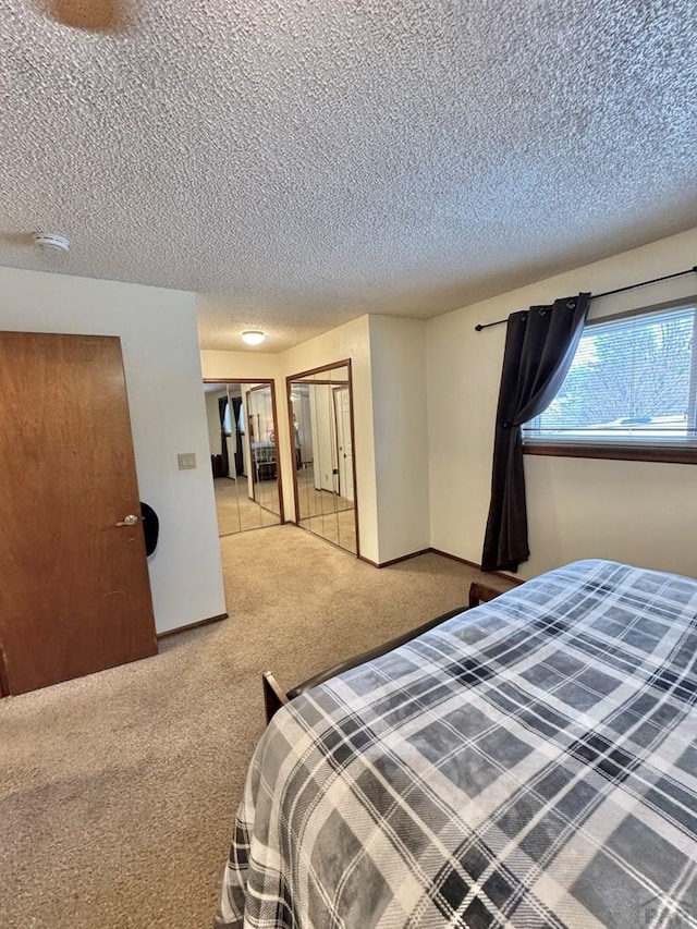 bedroom with carpet flooring and a textured ceiling