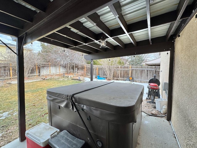 view of patio / terrace featuring a fenced backyard and a hot tub