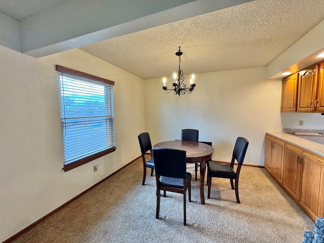 dining area featuring light colored carpet, a notable chandelier, a textured ceiling, and baseboards