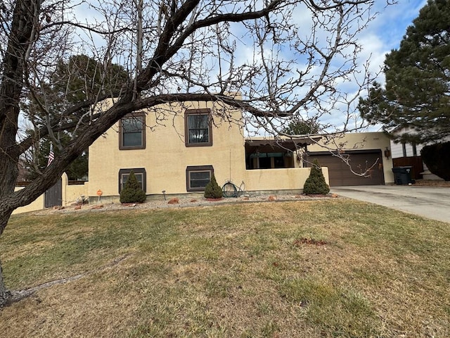 view of front of property with a garage, a front lawn, and stucco siding