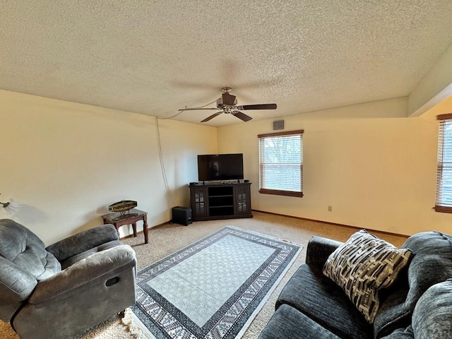 living area featuring light colored carpet, ceiling fan, visible vents, and baseboards