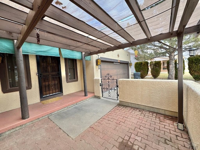 view of patio / terrace with a gate and a pergola