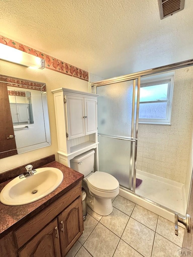 bathroom featuring a textured ceiling, vanity, tile patterned flooring, and visible vents