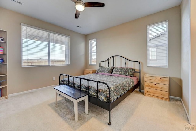 bedroom featuring light carpet, a ceiling fan, visible vents, and baseboards