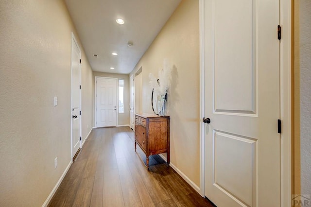 doorway to outside with recessed lighting, dark wood finished floors, and baseboards