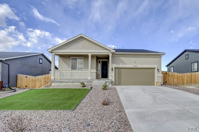 view of front facade with a garage, driveway, a porch, and stucco siding