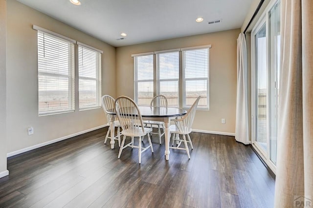 dining room with dark wood-style floors, baseboards, and recessed lighting