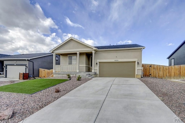 ranch-style home featuring covered porch, concrete driveway, a garage, and stucco siding