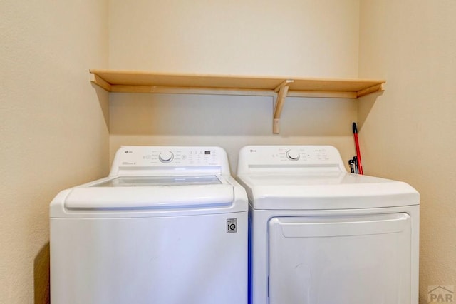 washroom with laundry area and washing machine and clothes dryer