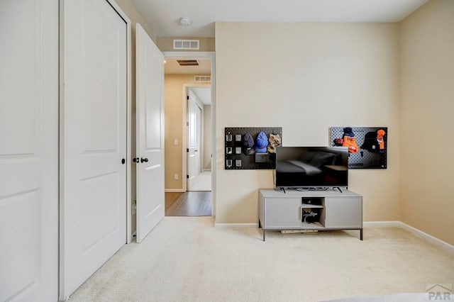 interior space with carpet, visible vents, and baseboards