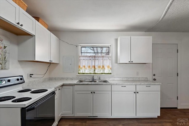 kitchen featuring white cabinets, a sink, light countertops, and electric range oven