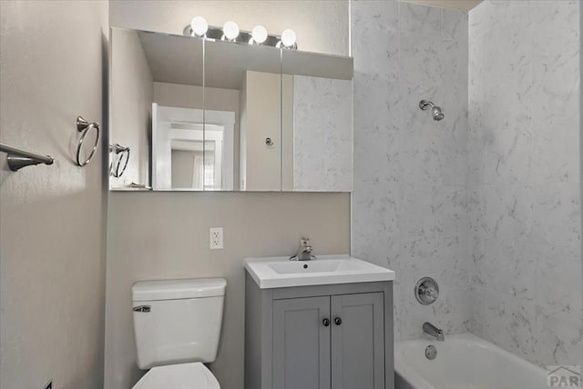 bathroom featuring toilet, washtub / shower combination, and vanity