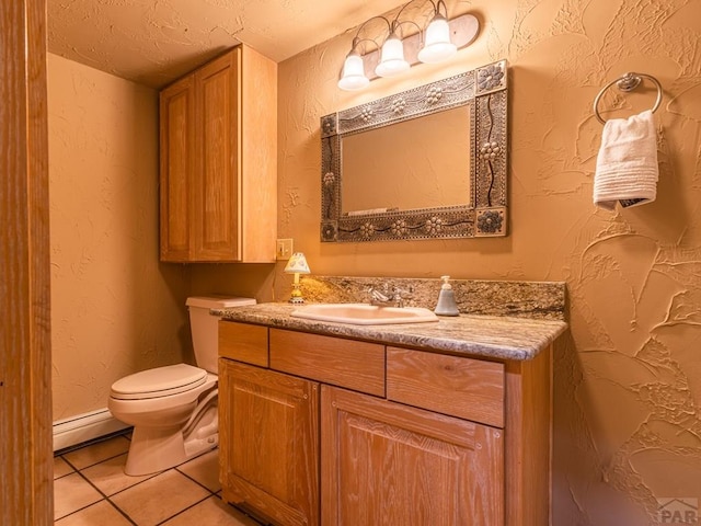 109 County Rd 405, Cuchara, CO 81055 - half bathroom with baseboard heating, toilet, tile patterned floors, vanity, and baseboards