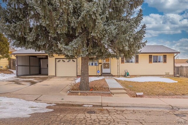 obstructed view of property with a garage and concrete driveway