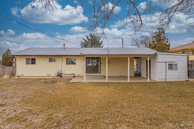 back of house featuring a lawn, a patio area, and fence