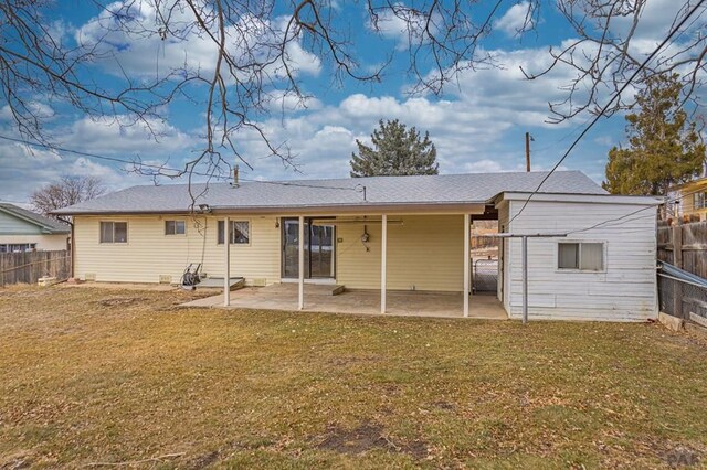 rear view of house featuring a patio area, a lawn, and a fenced backyard