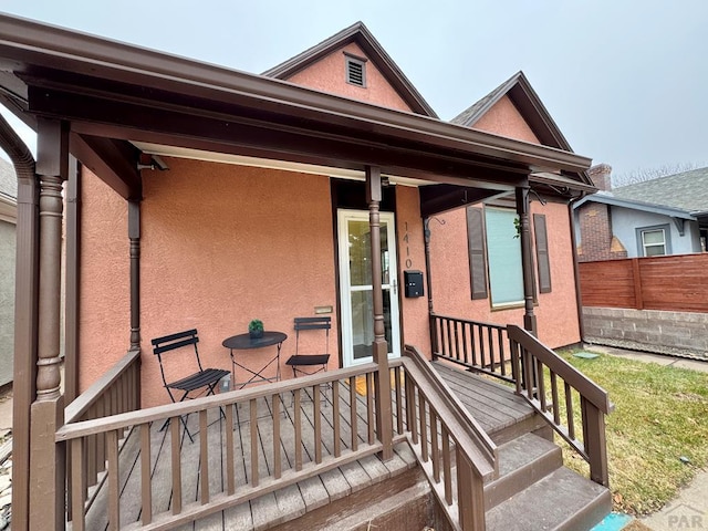 exterior space featuring fence and stucco siding