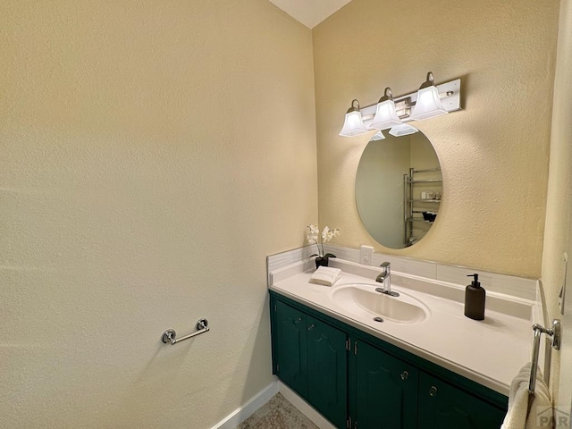 bathroom with vanity and baseboards