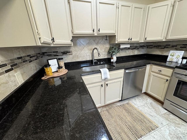 kitchen with tasteful backsplash, appliances with stainless steel finishes, dark stone counters, and a sink