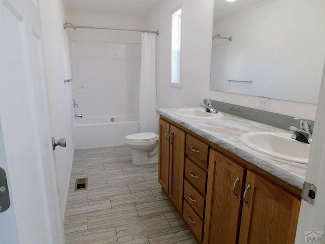 bathroom with double vanity, shower / tub combo, visible vents, and a sink