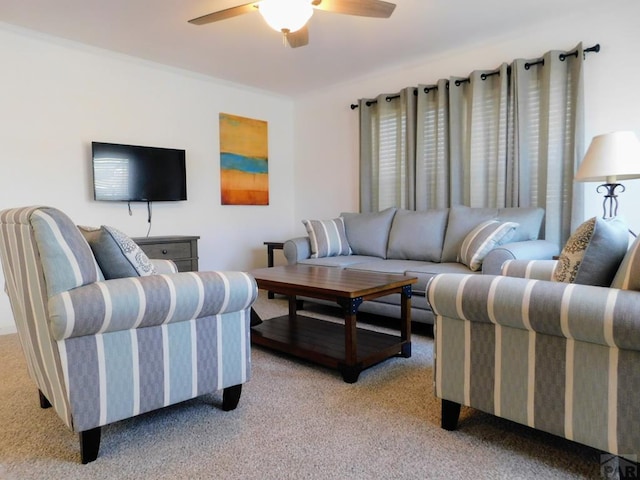 living area with light carpet and ceiling fan