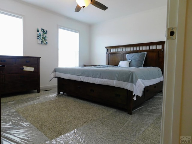 bedroom featuring baseboards and a ceiling fan