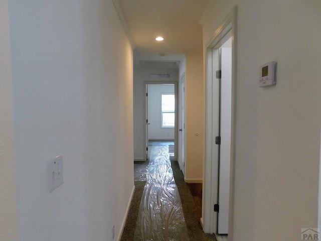 hallway with baseboards and recessed lighting