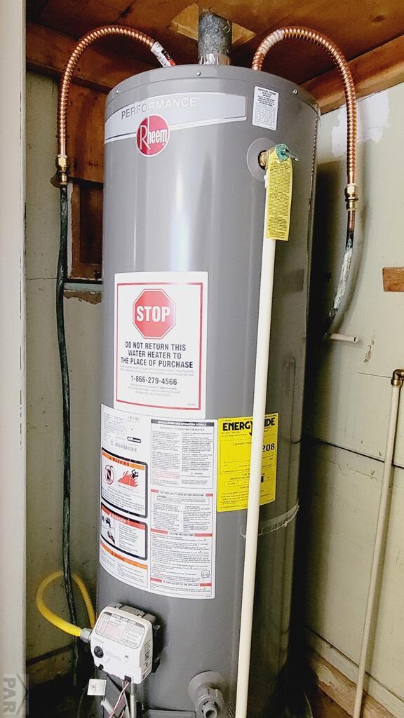 utility room featuring strapped water heater