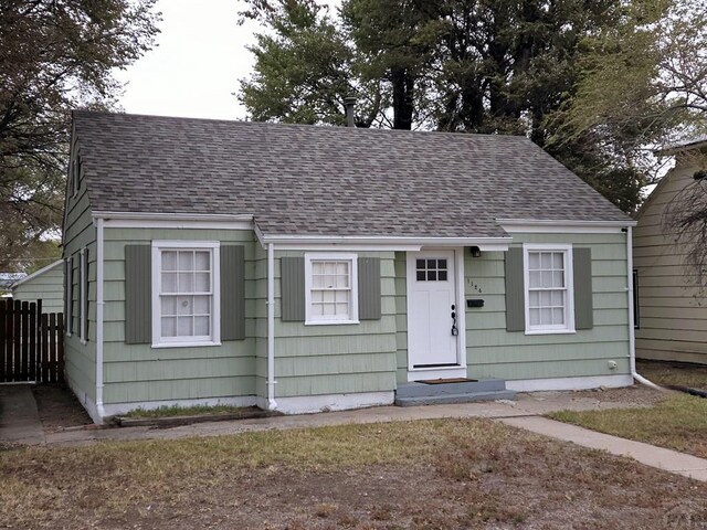 view of front facade with roof with shingles