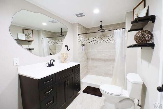 full bath with toilet, vanity, a shower stall, and visible vents