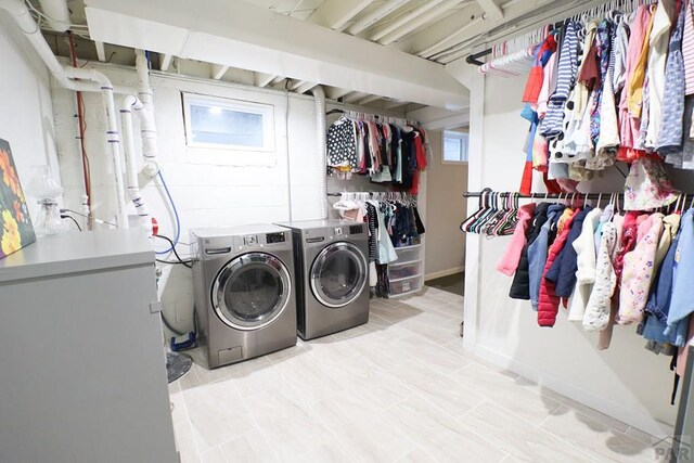 clothes washing area with washer and dryer and laundry area