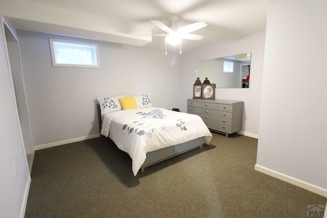 bedroom with ceiling fan, baseboards, and dark colored carpet