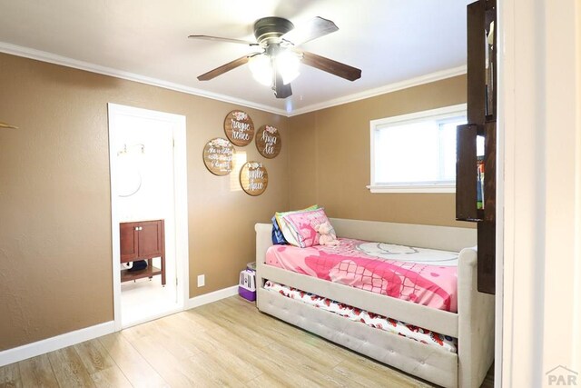 bedroom with baseboards, ornamental molding, a ceiling fan, and light wood-style floors