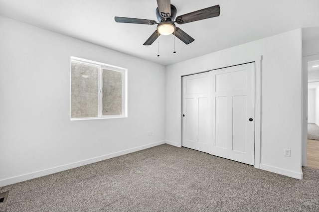 unfurnished bedroom with a ceiling fan, a closet, carpet flooring, and baseboards