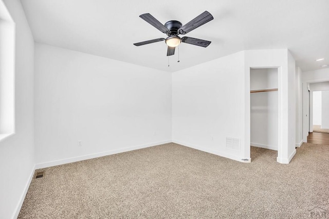 unfurnished bedroom with a closet, visible vents, baseboards, and carpet flooring