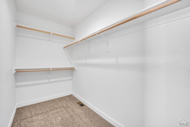 walk in closet featuring carpet floors and visible vents