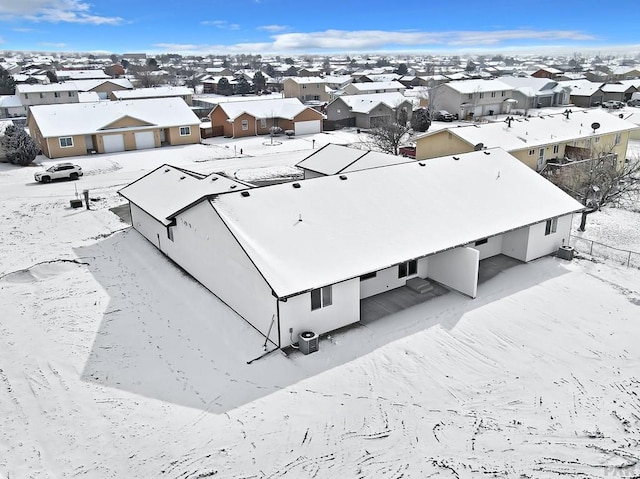 snowy aerial view featuring a residential view