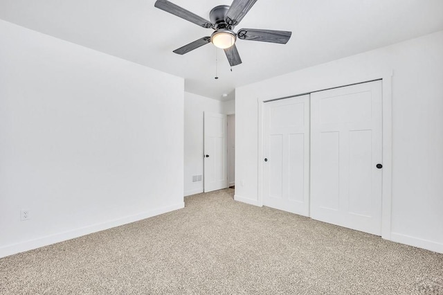 unfurnished bedroom with light carpet, a ceiling fan, baseboards, and a closet