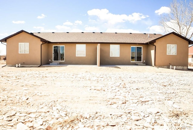 rear view of property featuring a patio area and stucco siding